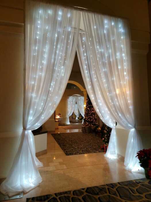 Lighted archway with white draping